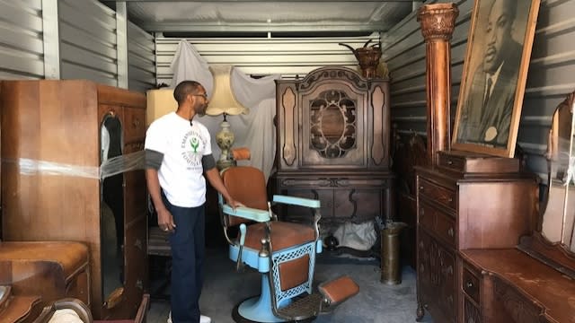 Person standing inside a storage unit.