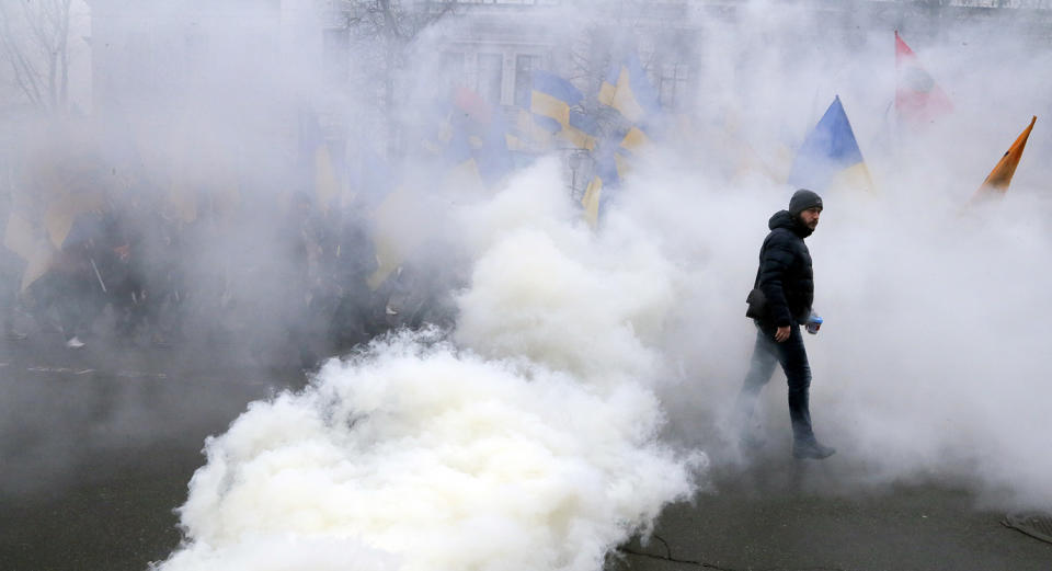 <p>A member of a nationalist group march through a smoke in the Ukrainian capital to mark the third anniversary of the Maidan protests in Kiev, Ukraine, Feb. 22, 2017. (AP Photo/Efrem Lukatsky) </p>