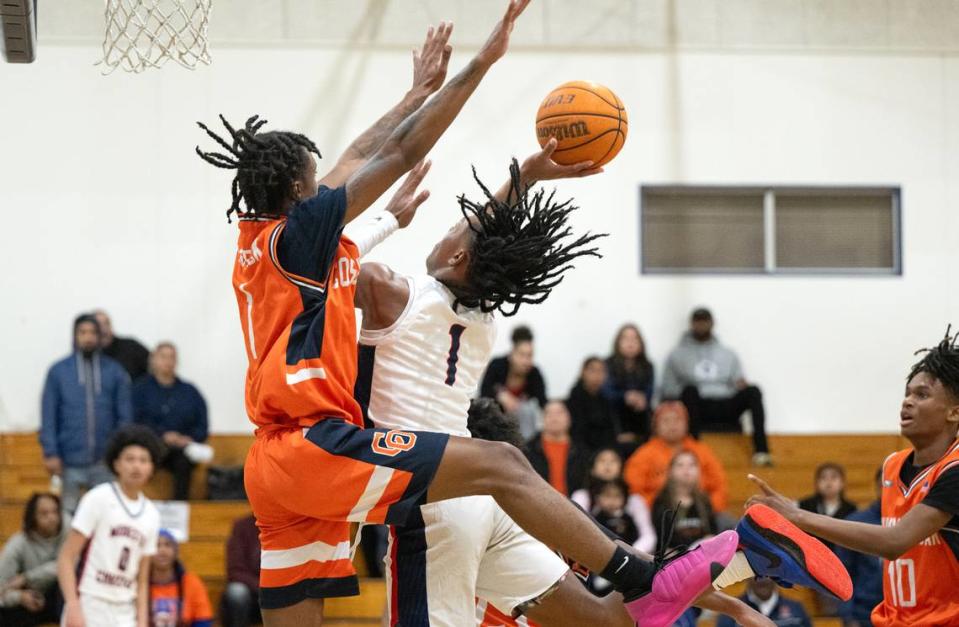 Modesto Christian’s Jeremiah Bernard challenges Jay Washington at the basket during the Sac-Joaquin Section Division I playoff game with Cosumnes Oaks at Modesto Christian High School in Salida, Calif., Wednesday, Feb. 14, 2024.