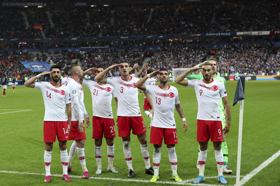 Turkey's players salute as they celebrate a goal against France during the Euro 2020 group H qualifying soccer match between France and Turkey at Stade de France at Saint Denis, north of Paris, France, Monday, Oct. 14, 2019. (AP Photo/Thibault Camus)