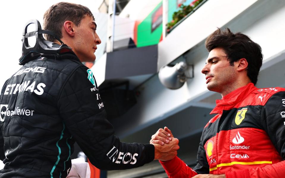 George Russell (left) is congratulated by Ferrari's Carlos Sainz (right) - GETTY IMAGES