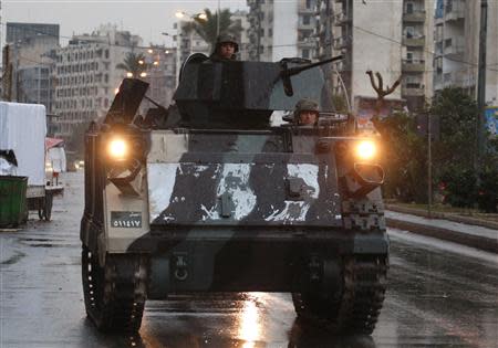 Lebanese army soldiers ride a military vehicle as they are deployed on the streets of Tripoli, northern Lebanon, December 3, 2013. REUTERS/Stringer