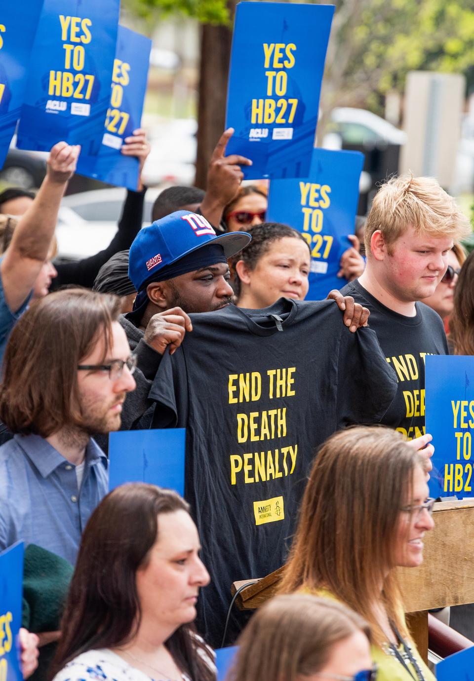 LeAndrew Hood, center, holds an End the Death Penalty t-shirt during a rally in support of HB27 at the Alabama Statehouse in Montgomery, Ala., on Thursday March 21, 2024.The bill would retroactively abolish judicial override in Alabama.