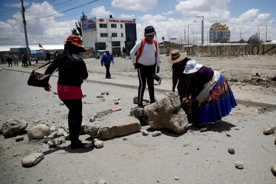 Supporters of former President Evo Morales set up barricades at the road leading to a gas plant in El Alto, on the outskirts of La Paz, Bolivia, Tuesday, Nov. 19, 2019. Morales' backers have taken to the streets asking for his returns since he resigned on Nov. 10 under pressure from the military after weeks of protests against him over a disputed election he claim to have won. (AP Photo/Natacha Pisarenko)