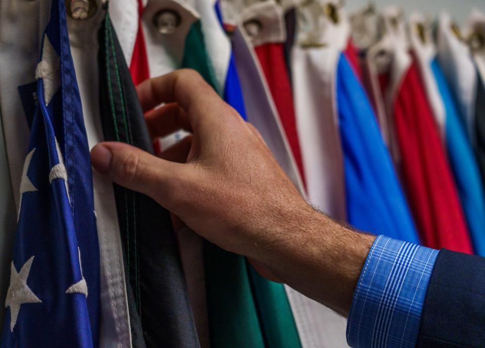 Peter Kirkwood, the International Center's chief protocol officer, thumbs threw flags of the United Nations inside the non-profit's 20th floor Regions Tower office in Indianapolis.  "WIth the U.S. flag you learn the symbolism," Kirkwood said Thursday, May 12, 2022. "As you step back and see how much is packed into these 3x5 symbols. It's something we take a lot of pride in, in terms of the protocol of displays." For various events, the International Center will display all of the flags of the United Nations. It takes a couple of hours, and Kirkwood says he sometimes questions if the work involved in displaying them properly is worth it. Then, he says, someone will want a photo in front of their nation's flag or will interact with the flags and it reminds him of their importance.