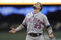 New York Mets' Javier Baez (23) looks up as rain falls from the roof during the eighth inning of a baseball game against the Milwaukee Brewers, Friday, Sept. 24, 2021, in Milwaukee. (AP Photo/Aaron Gash)