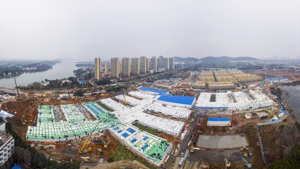 The Huoshenshan temporary field hospital under construction is seen as it nears completion in Wuhan in central China's Hubei Province, Sunday, Feb. 2, 2020. The Philippines on Sunday reported the first death from a new virus outside of China, where authorities delayed the opening of schools in the worst-hit province and tightened quarantine measures in a city that allow only one family member to venture out to buy supplies. (Chinatopix via AP)