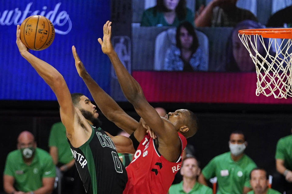 Boston Celtics' Jayson Tatum (0) tries to get a shot over Toronto Raptors' Serge Ibaka (9) during the second half of an NBA conference semifinal playoff basketball game Monday, Sept. 7, 2020, in Lake Buena Vista, Fla. (AP Photo/Mark J. Terrill)