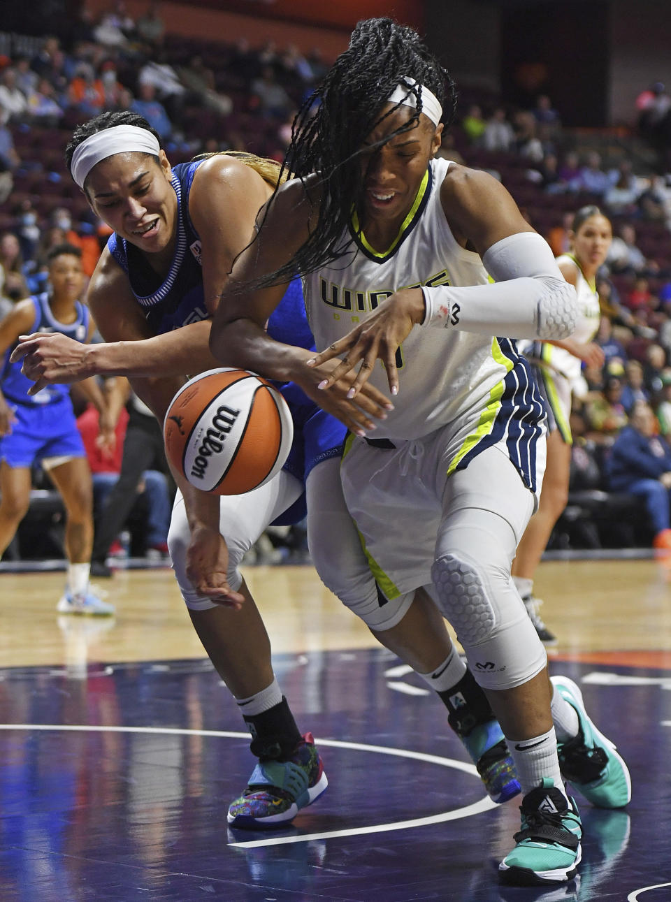 Connecticut Sun center Brionna Jones, left, and Dallas Wings forward Kayla Thornton (6) vie for the ball during a WNBA basketball game Tuesday, May 24, 2022, in Uncasville, Conn. (Sean D. Elliot/The Day via AP)