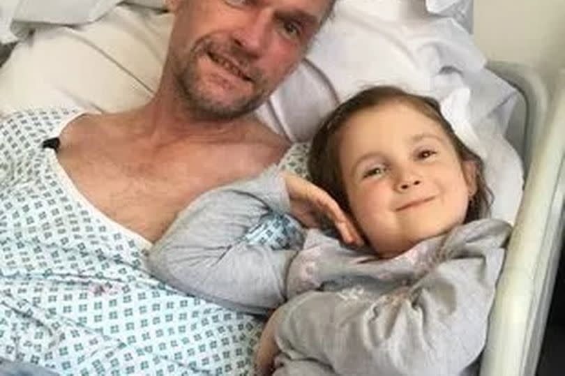 Martin Williams in hospital with his eldest daughter Stephanie -Credit:Martin Williams/SWNS