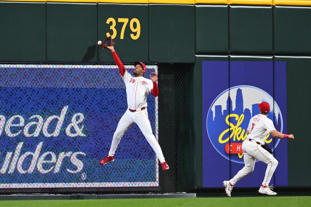 CINCINNATI, OHIO - APRIL 09: Will Benson #30 of the Cincinnati Reds misses a catch against the wall in the seventh inning of a game against the Milwaukee Brewers at Great American Ball Park on April 09, 2024 in Cincinnati, Ohio. (Photo by Ben Jackson/Getty Images)
