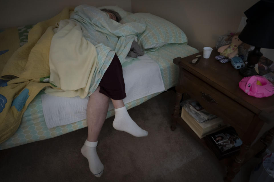 Betty Bednarowski, 79, lies in bed asleep, early Tuesday, Nov. 30, 2021, in Rotterdam Junction, N.Y. (AP Photo/Wong Maye-E)