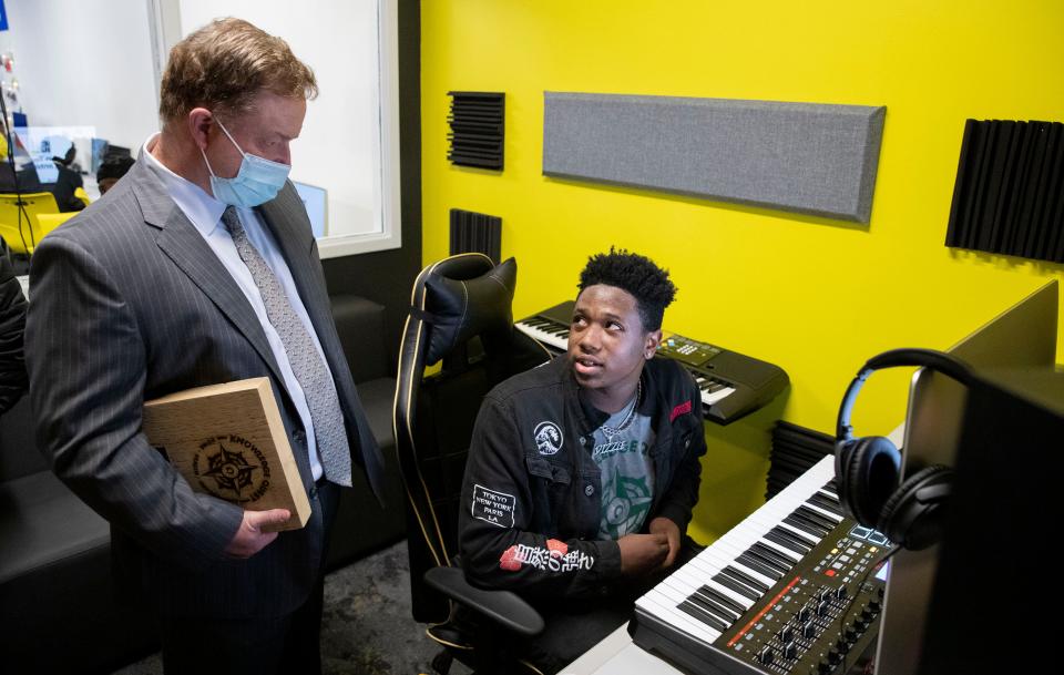 Omaron Cowley speaks with Jason Little, CEO of Baptist Memorial Healthcare, about recording equipment available to for kids to use Tuesday, Jan. 18, 2022, during the grand opening of a Best Buy Teen Tech Center in South Memphis. The center allows middle and high school aged kids to explore technology related to fashion, programming, photography, music production and recording and film.