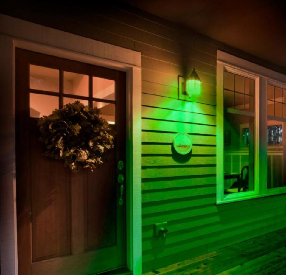 Front porch of home illuminated with a green light bulb to support veterans.