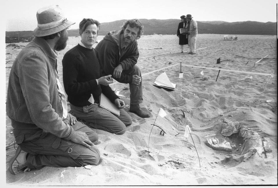 From the left: John Parker, Glen Wharton, Peter Brosnan look over a dig exposing a piece of plaster set from the Ten Comandments, the 1923 black and white version of the film by Cecil B. DeMille filmed in the Guadalupe Dunes. They were working on an archeological investigation of the fragile site Nov. 19, 1990.