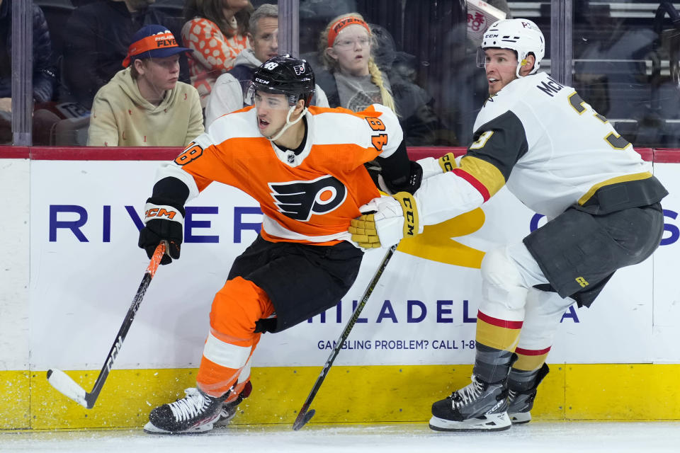 Vegas Golden Knights' Brayden McNabb, right, tries to slow Philadelphia Flyers' Morgan Frost during the second period of an NHL hockey game, Tuesday, March 14, 2023, in Philadelphia. (AP Photo/Matt Slocum)