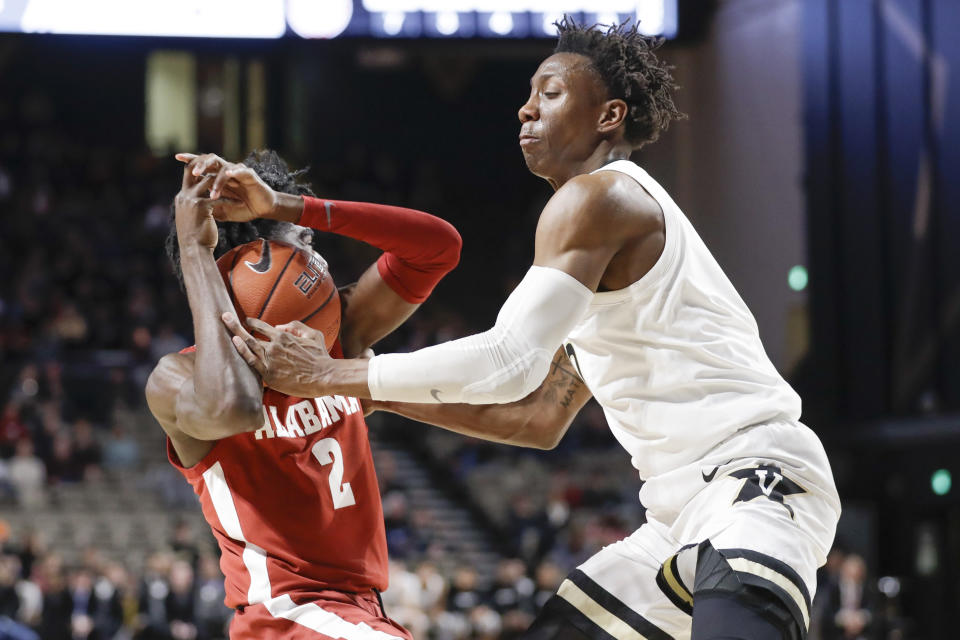 Alabama guard Kira Lewis Jr. (2) and Vanderbilt guard Saben Lee battle for the ball in the second half of an NCAA college basketball game Wednesday, Jan. 22, 2020, in Nashville, Tenn. (AP Photo/Mark Humphrey)