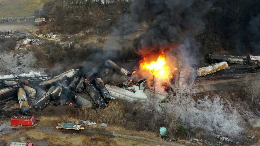 FILE - This photo taken with a drone shows portions of a Norfolk Southern freight train that derailed the night before in East Palestine, Ohio, still on fire at mid-day on Feb. 4, 2023. The railroad industry is trying to make sure that emergency responders can quickly look up what is on a train when they respond to a derailment. In the chaos after a Norfolk Southern train derailed and caught fire in eastern Ohio in February, firefighters couldn't find that information for roughly 45 minutes. (AP Photo/Gene J. Puskar, File)