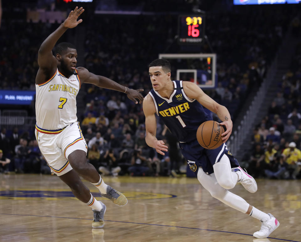 Denver Nuggets' Michael Porter Jr., right, drives the ball against Golden State Warriors' Eric Paschall (7) during the first half of an NBA basketball game Thursday, Jan. 16, 2020, in San Francisco. (AP Photo/Ben Margot)