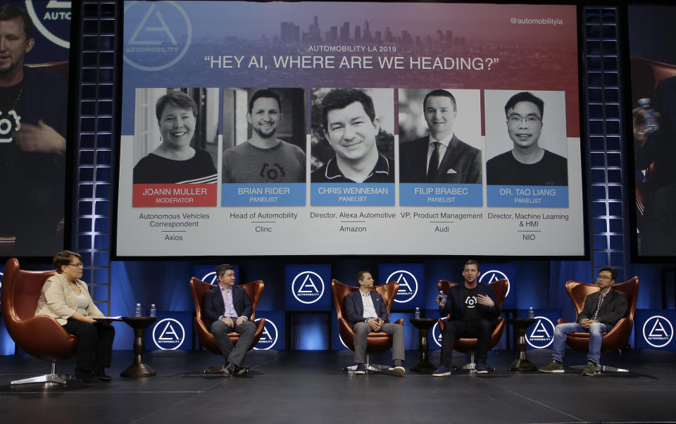 From left to right, moderator Joann Muller, Autonomous Vehicles Correspondent Axios, and panelists Chris Wenneman, director of Alexa Automotive, Amazon, Filip Brabec, Audi vice president of Product Management, Brian Rider, head of automobility at Clinic, Dr. Tao Liang, director ofMachine Learning & HMI at NIO participate in the technology panel "Hey AI, Where are We Heading?" at the AutoMobility LA auto show the Los Angeles Convention Center in Los Angeles Tuesday, Nov. 19, 2019. (AP Photo/Damian Dovarganes)