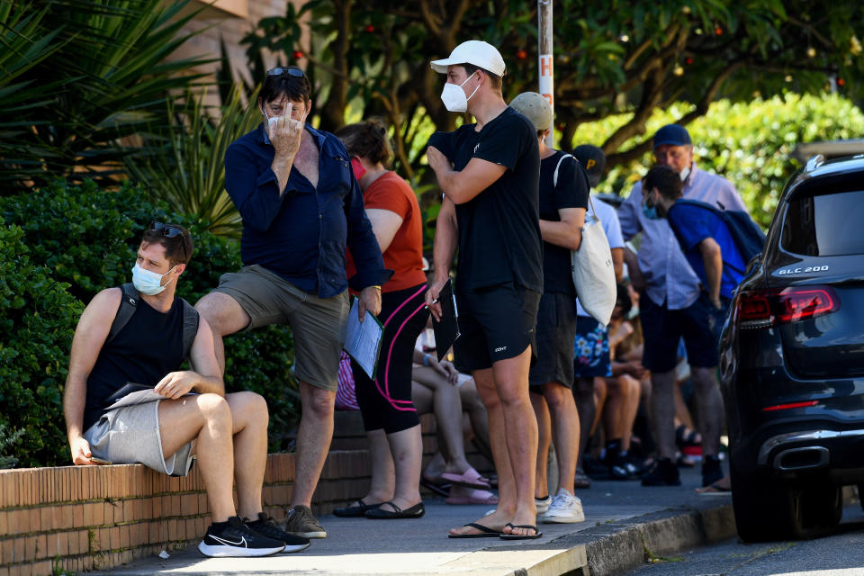 Members of the public queue for a Covid-19 PCR test in Sydney. Some less happy than others. Source: AAP