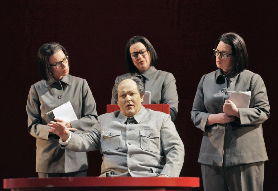 In this June 5, 2012 handout photo provided by the San Francisco Opera, Simon O’Neill, as Mao Tse-tung, foreground, is shown with his three secretaries—Ginger Costa Jackson, from left, Buffy Baggott and Nicole Birkland, during a scene from the final dress rehearsal of Nixon in China. The production, increasingly recognized as a modern masterpiece, is finally getting the recognition it deserves on the home ground of composer John Adams, in a sparkling production that highlights the San Francisco Opera's summer season. (AP Photo/San Francisco Opera, Cory Weaver, handout)