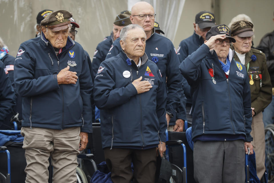 U.S. war veterans salute during a ceremony to mark the 79th anniversary of the assault that led to the liberation of France and Western Europe from Nazi control, at the American Cemetery in Colleville-sur-Mer, Normandy, France, Tuesday, June 6, 2023. The American Cemetery is home to the graves of 9,386 United States soldiers. Most of them lost their lives in the D-Day landings and ensuing operations. (AP Photo/Thomas Padilla)