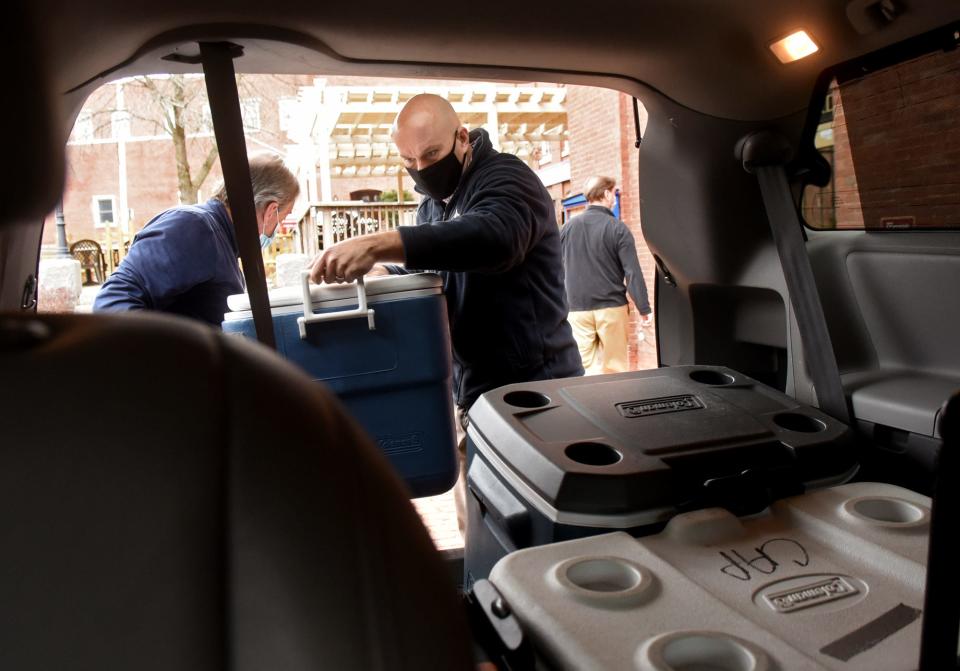 Dover Police Chief Bill Breault loads a cooler full of Thanksgiving meals into a van at Blue Latitudes after volunteers prepared and deliver around 600 meals to Dover residents in need two years ago during the COVID-19 pandemic.