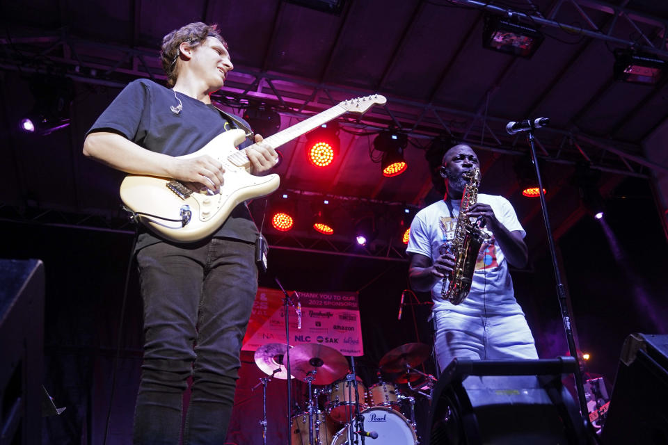 Mike Phillips, right, performs at the Jefferson Street Jazz & Blues Festival July 23, 2022, in Nashville, Tenn. Hundreds of tourism-related projects nationwide, including the festival, collectively are getting about $2.4 billion from the American Rescue Plan, according to an Associated Press analysis of funds flowing from last year's wide-ranging coronavirus relief law. (AP Photo/Mark Humphrey)