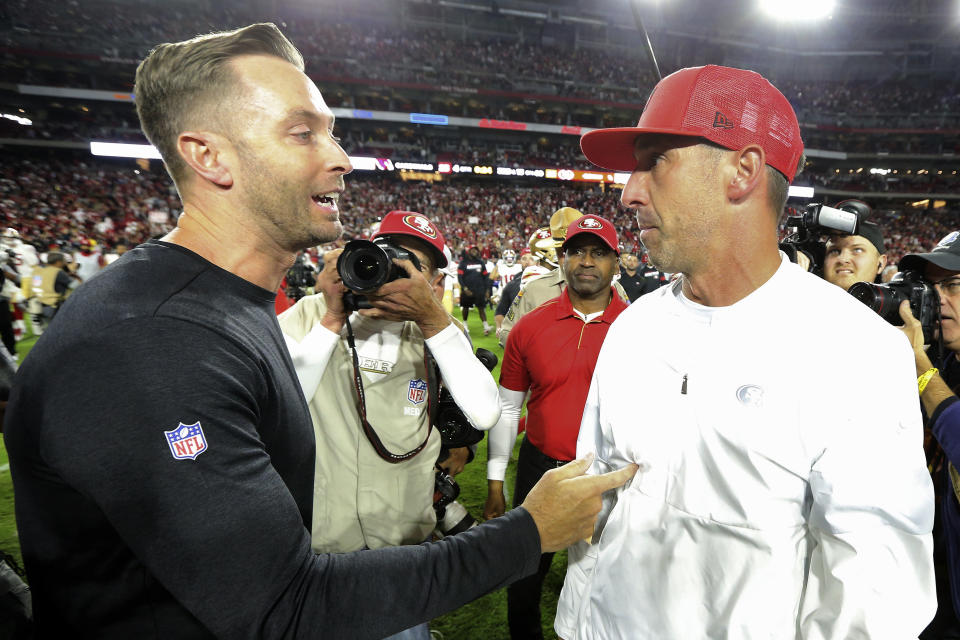 Arizona Cardinals head coach Kliff Kingsbury, left, greets San Francisco 49ers head coach Kyle Shanahan after an NFL football game, Thursday, Oct. 31, 2019, in Glendale, Ariz. The 49ers won 28-25. (AP Photo/Ross D. Franklin)