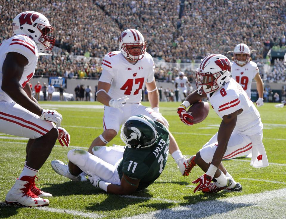 Sojourn Shelton, right, had one of three interceptions for Wisconsin in a win over Michigan State. (AP Photo/Al Goldis)