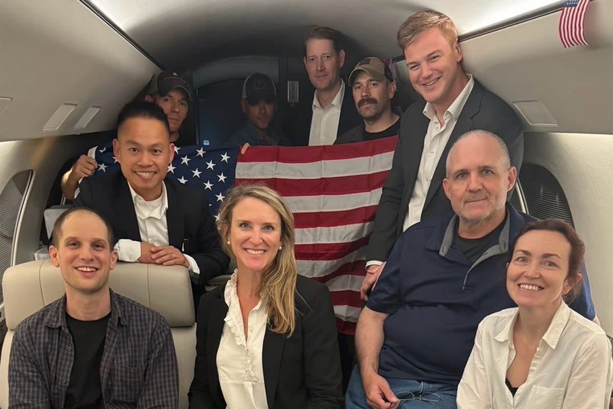 US journalist Evan Gershkovich (left), former US Marine Paul Whelan (second from right) and US-Russian journalist Alsu Kurmasheva (right) are seen on a plane after their release from Russia on August 1 (US Government/AFP/Getty)