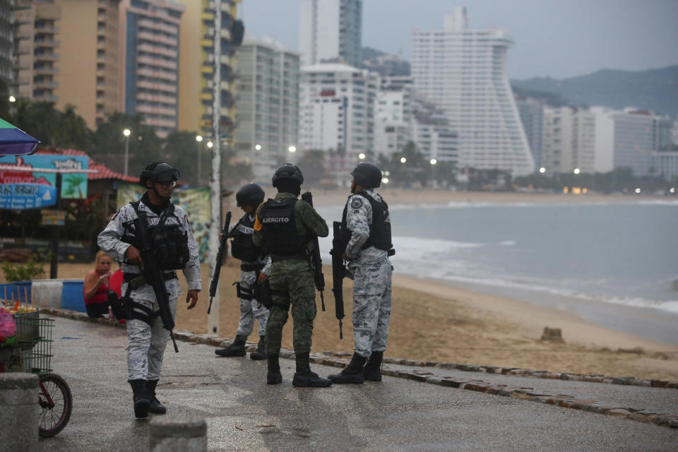 Members of the federal forces chat as they keep watch at a beach as Hurricane Otis barrels towards Acapulco, Mexico, Oct. 24, 2023. / Credit: JAVIER VERDIN/REUTERS