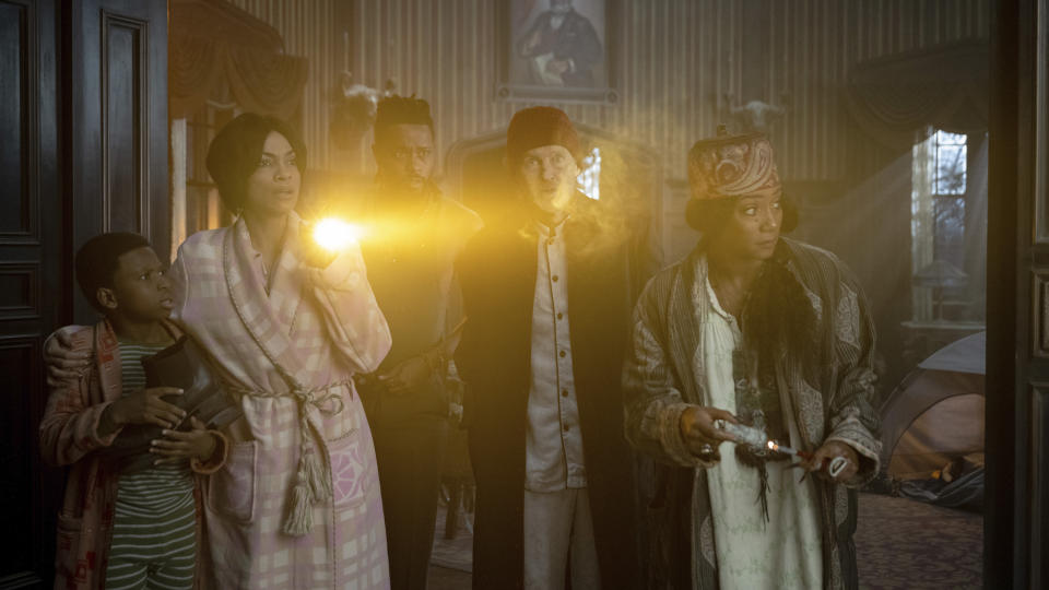 This image released by Disney Enterprises shows, from left, Chase Dillon, Rosario Dawson, LaKeith Stanfield, Owen Wilson and Tiffany Haddish in a scene from "Haunted Mansion." (Disney Enterprises via AP)