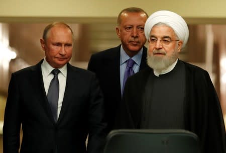 Presidents Rouhani of Iran, Erdogan of Turkey and Putin of Russia arrive for a news conference in Ankara