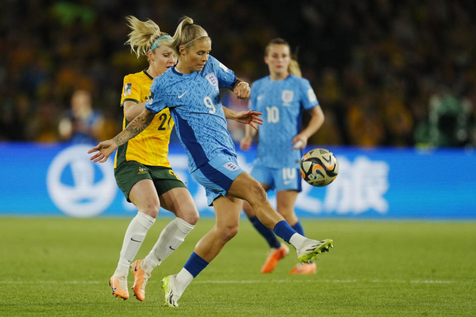 England's Rachel Daly, centre, and Australia's Ellie Carpenter, left, challenge for the ball during the Women's World Cup semifinal soccer match between Australia and England at Stadium Australia in Sydney, Australia, Wednesday, Aug. 16, 2023. (AP Photo/Abbie Parr)