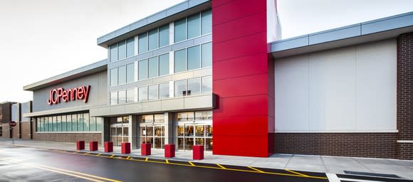 The outside of a JCPenney store with an empty parking lot.