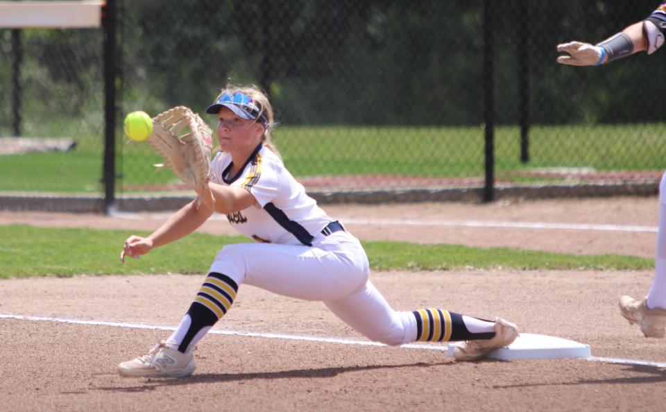 Hartland first baseman Kate McIntyre stretches to get a putout of South Lyon's Izabella DeGroat during a state Division 1 quarterfinal softball game Tuesday, June 11, 2024 at Albion College.