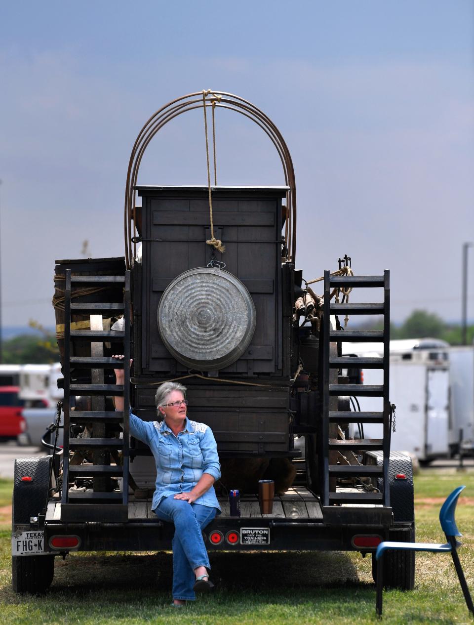 Kathy Bowen of Roscoe takes a rest after participating in the chuckwagon competition with the Scorpion Cattle Company.