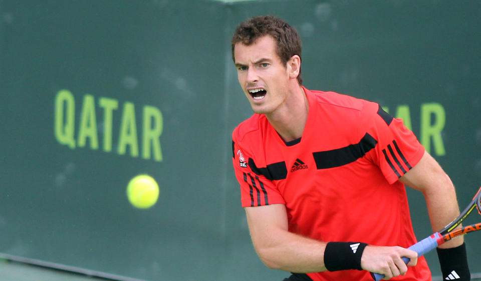 Andy Murray of Great Britain returns the ball to Florian Mayer of Germany during the Qatar ATP Open Tennis tournament in Doha, Qatar, Wednesday, Jan. 1, 2014.(AP Photo/Osama Faisal)