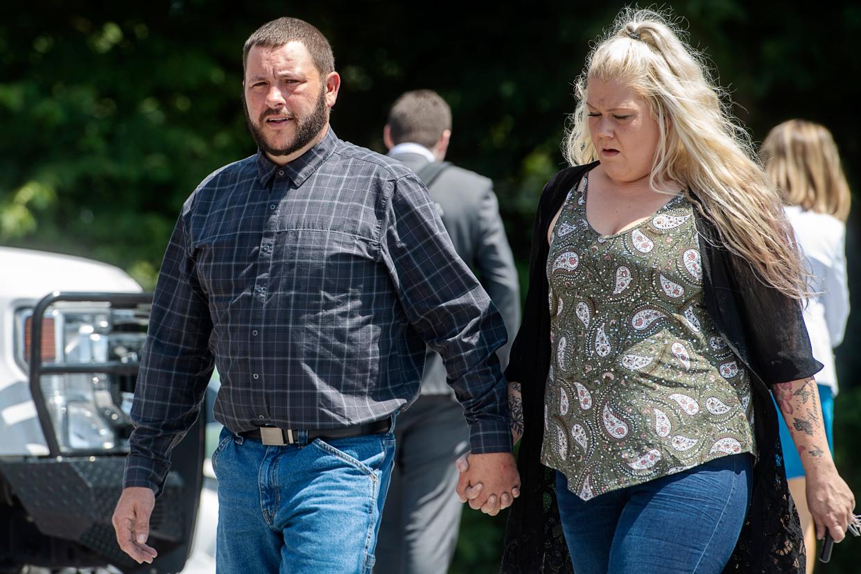 Johnathon Jessi McKinney and his wife, Brittany, walk to the Transylvania County Courthouse July 25, 2023.