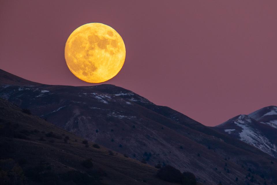 Beaver moon rising behind Gran Sasso dItalia picks is seen from LAquila, Italy, on November 7, 2022. November full moon takes this name because during this month beavers fill the banks of rivers and build their dams and dens to take refuge in view of winter. On november 8, 2022, the moon will be in its last total eclipse before 2025.