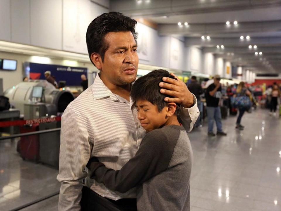 Mr Lara Lopez comforts his son before being deported to Mexico after 16 years in the US (Lisa DeJong/ The Plain Dealer)