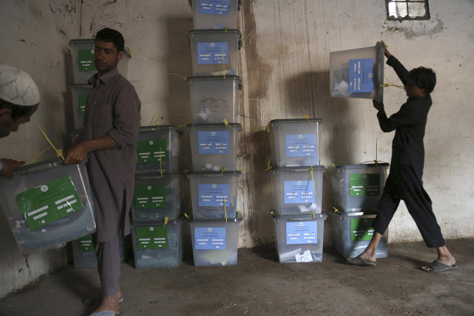 Afghan workers of the election commission office unload ballot boxes from a truck after votes in Jalalabad, east of Kabul, Afghanistan, Sunday, April 6, 2014. Across Afghanistan, voters turned out in droves Saturday to cast ballots in a crucial presidential election. The vote will decide who will replace President Hamid Karzai, who is barred constitutionally from seeking a third term. Partial results are expected as soon as Sunday. (AP photo/Rahmat Gul)