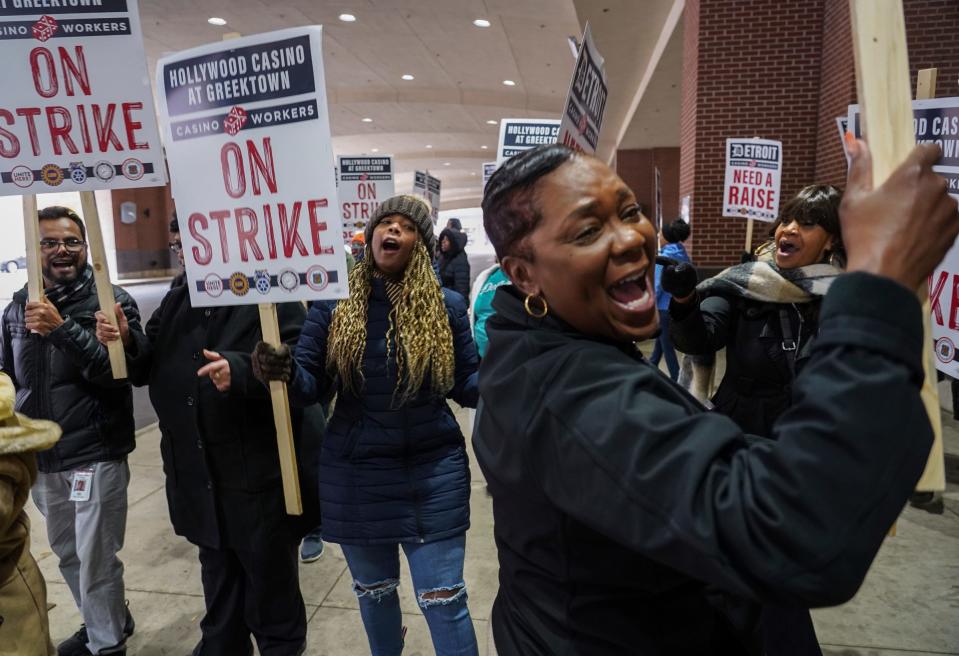 Chanett Watson, foreground, chants "If we don't get it, shut it down" with Terri Smith, left, and Demetra Montague, right, while on strike with coworkers outside of the Greektown Casino in downtown Detroit on Tuesday, October 17, 2023.