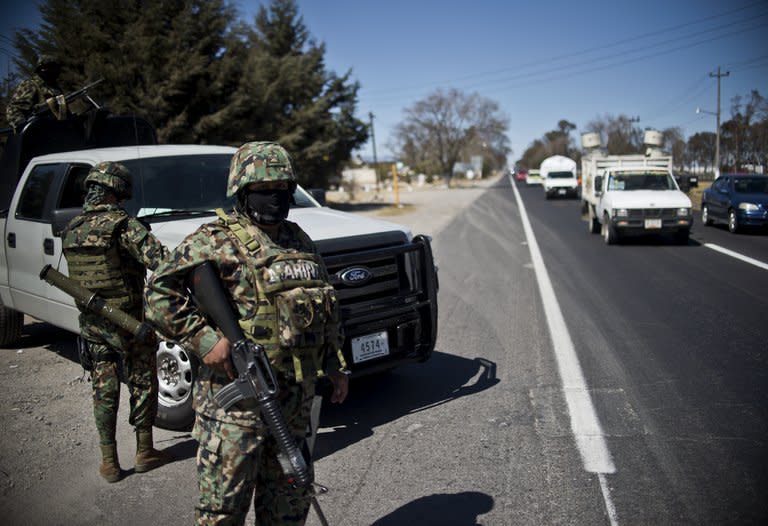 Members of the Mexican Navy patrol a highway in the state of Mexico, near the capital Toluca, on January 29, 2013. Some 50,000 troops were deployed across the nation by then president Felipe Calderon in 2006. Since then, more than 70,000 people have been killed in drug-related violence as cartels battle each other and the authorities