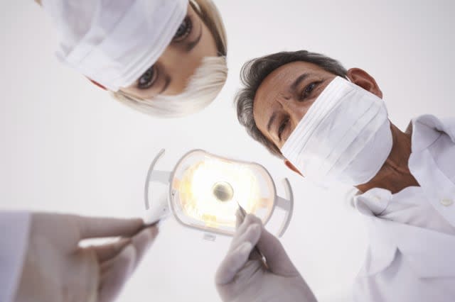 Shot of a dentist and his assistant at work during a routine checkuphttp://195.154.178.81/DATA/shoots/ic_783161.jpg