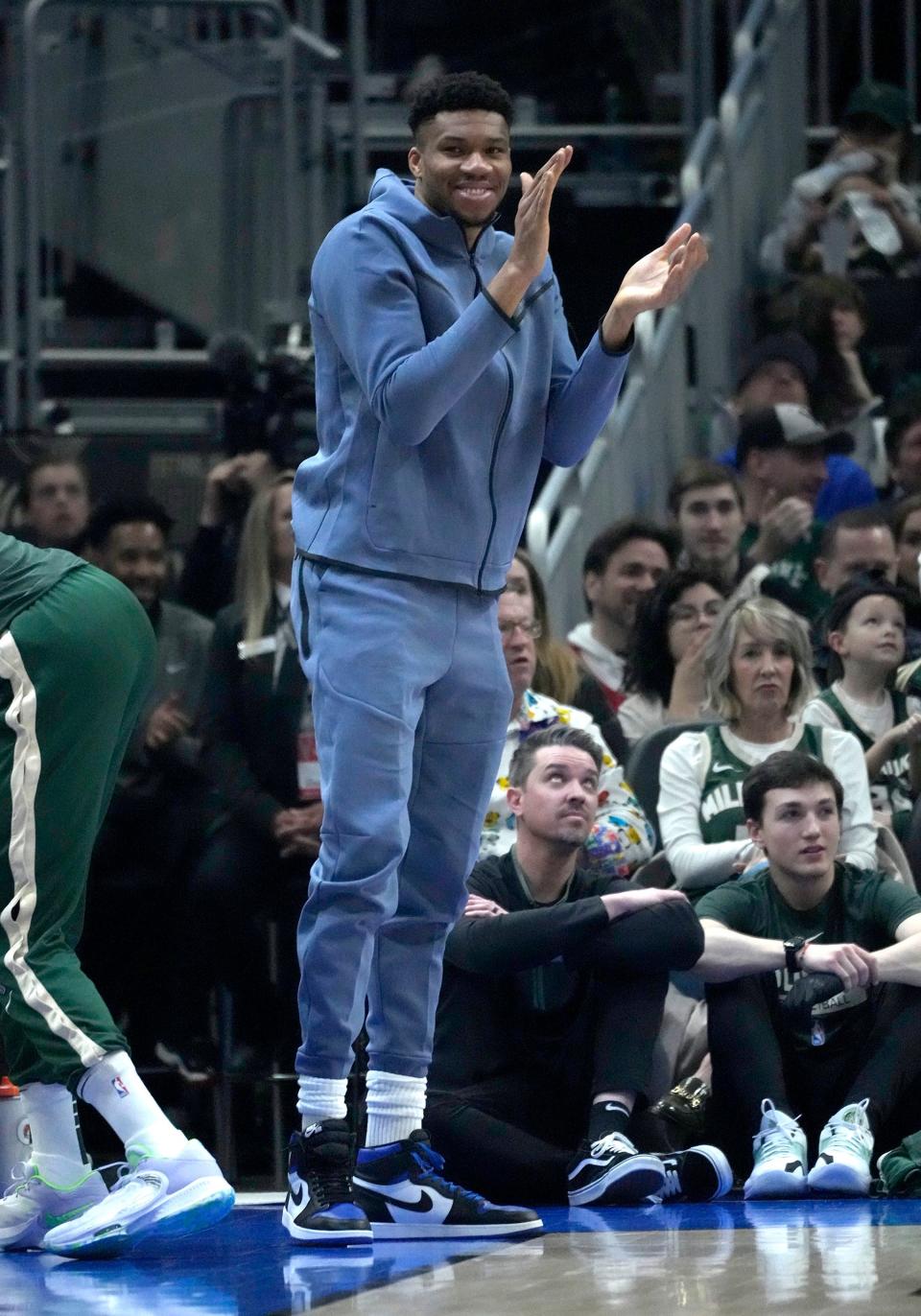 Milwaukee Bucks forward Giannis Antetokounmpo cheers from the bench as his teammates battle the Phoenix Suns at Fiserv Forum in Milwaukee on Sunday.