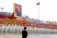 FILE PHOTO: Float carrying a portrait of Chinese President Xi Jinping moves through Tiananmen Square during the parade marking the 70th founding anniversary of People's Republic of China, on its National Day in Beijing