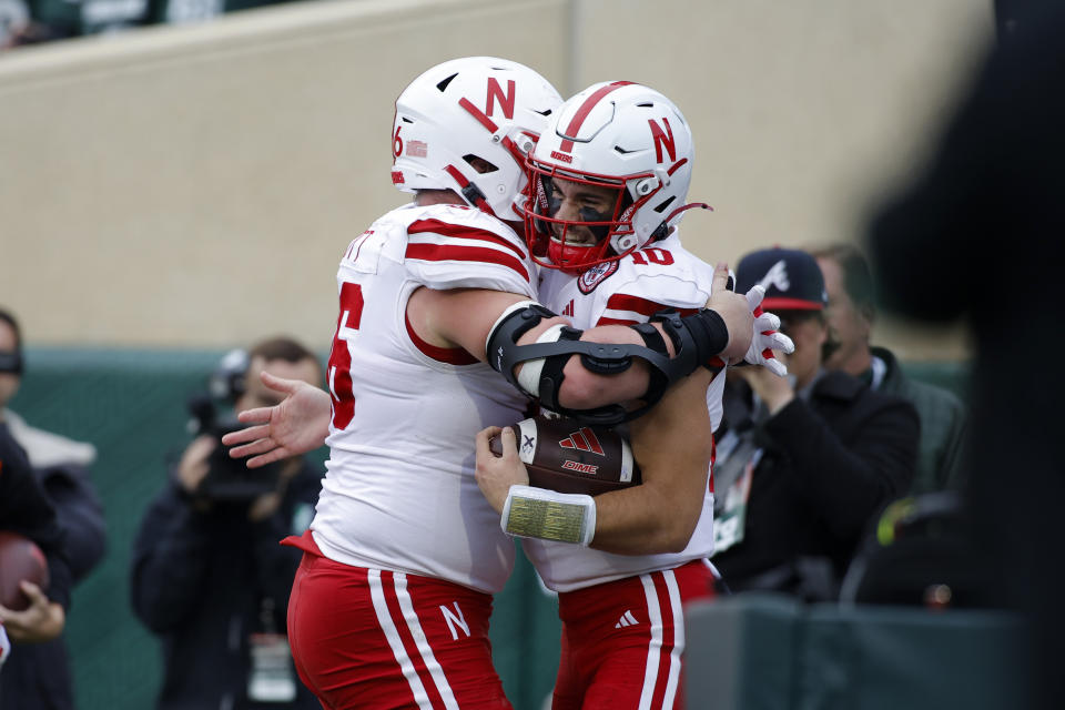 Nebraska quarterback Heinrich Haarberg, right, and offensive lineman Ben Scott celebrate Haarberg's rushing touchdown against Michigan State during the first half of an NCAA college football game, Saturday, Nov. 4, 2023, in East Lansing, Mich. (AP Photo/Al Goldis)